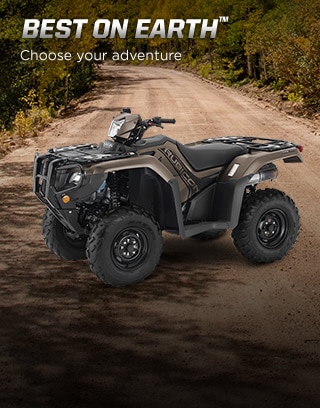 "Honda's line of ATVs has earned a solid and well-deserved reputation for being some of the most durable ATVs on the planet" - quote by Outdoorlife.com. Image of rider in denim shirt driving through thick muddy trail in the forest.