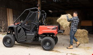 Farmer putting hay in the tilt box